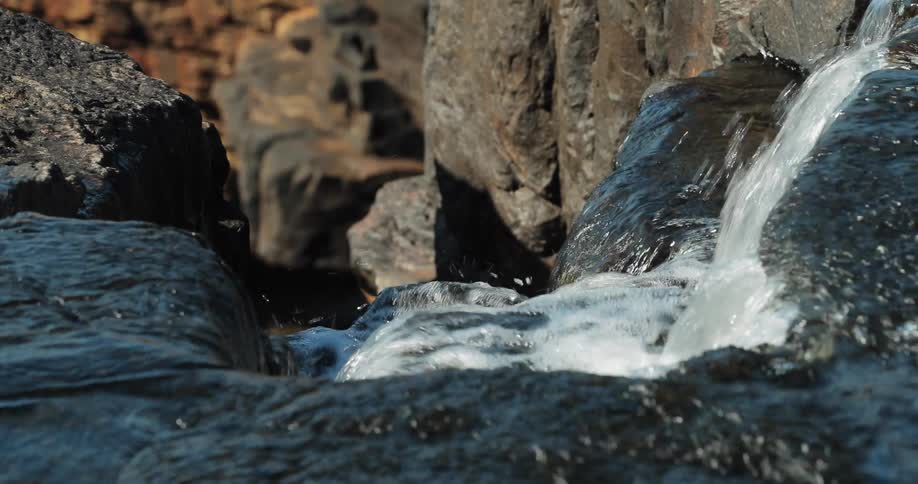 Water slowly moves over the rocks
