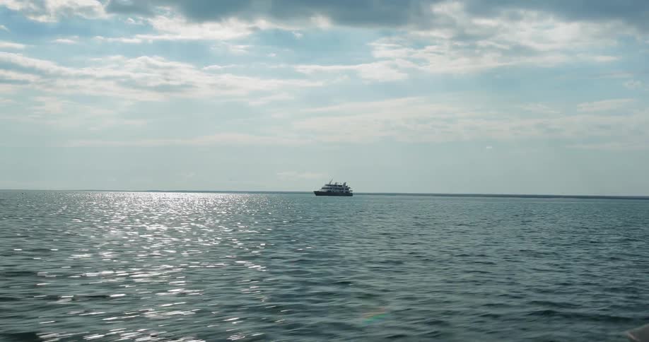 A large boat sits alone out in the open water