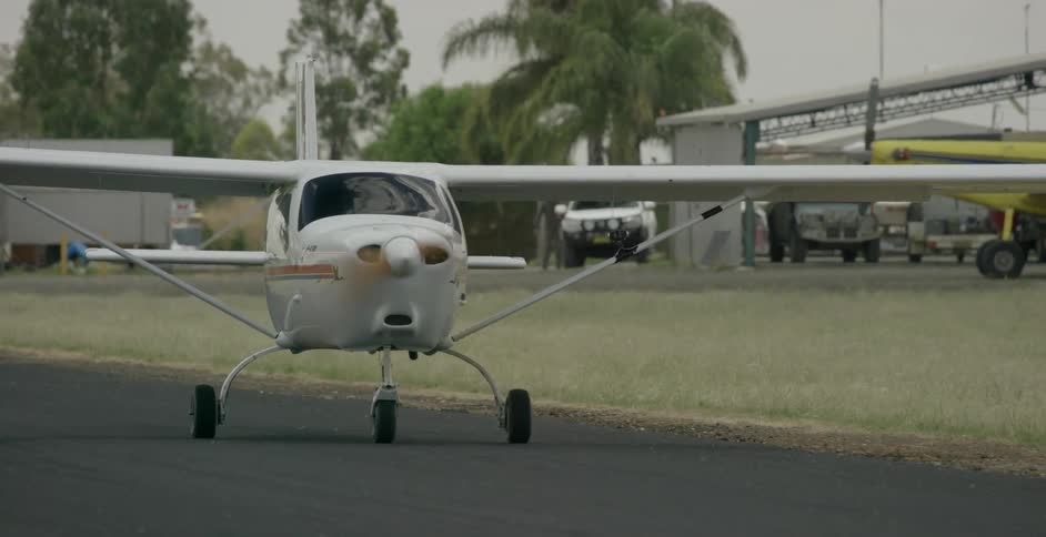 A small aircraft drives on a rural runway