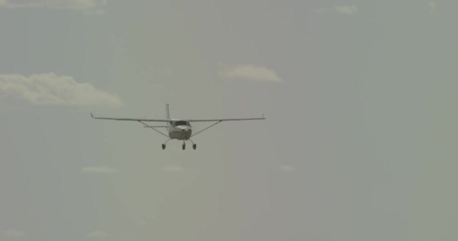 A small plane flies steadily