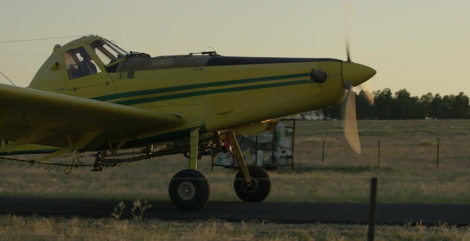 A single engine plane is taxiing down a runway