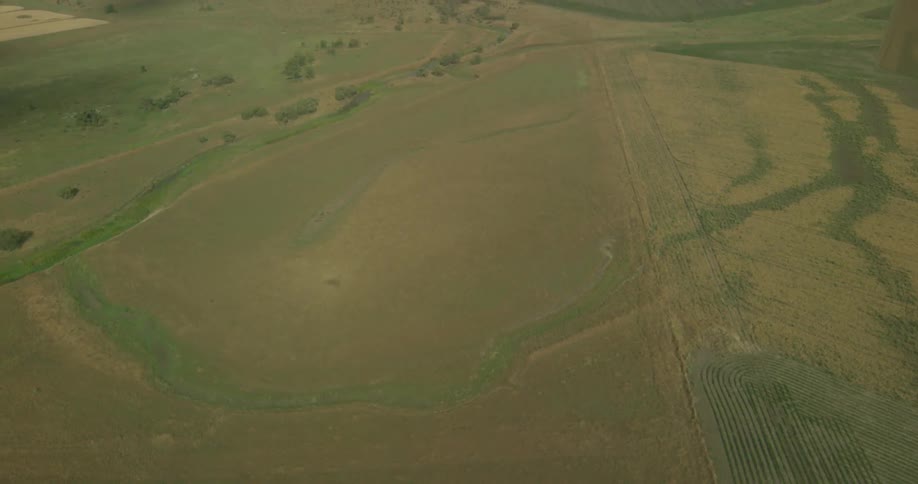The field below is flat and green