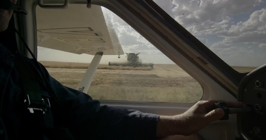 A man pilots a plane down a tarmac readying for takeoff