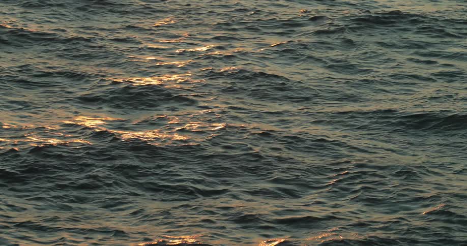 Orange light reflecting off of water