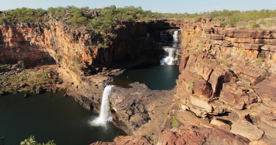 Waterfalls cascade over a rocky cliffside