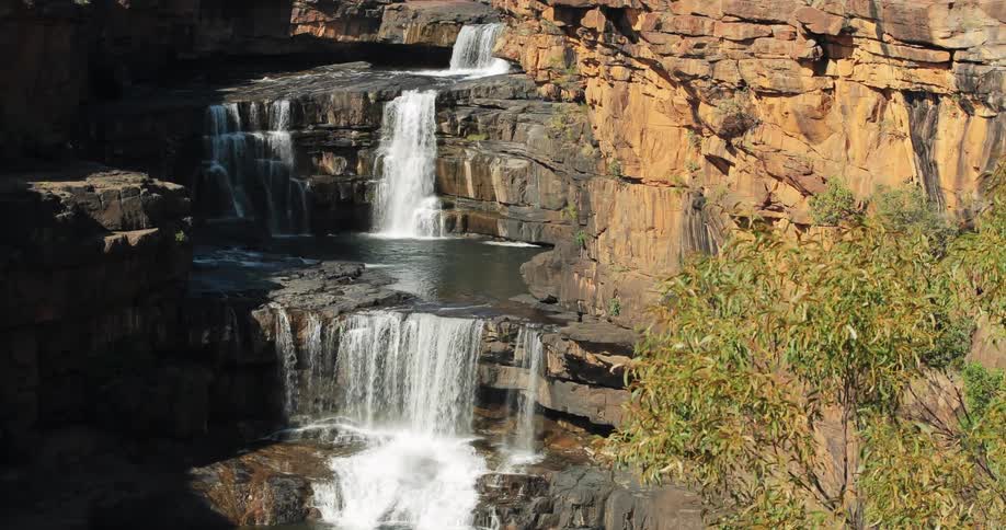 Waterfalls cascade over rocky cliffs