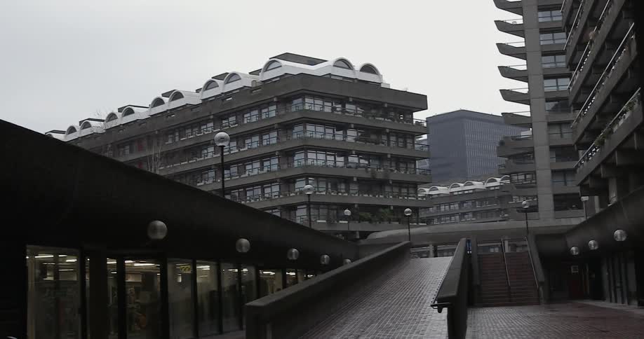 Ramp leading up to a bridge with buildings behind it