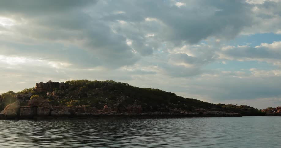 Traveling view of a body of water and an island