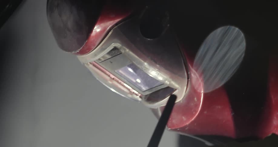 Close up of a red helmet illuminated by light