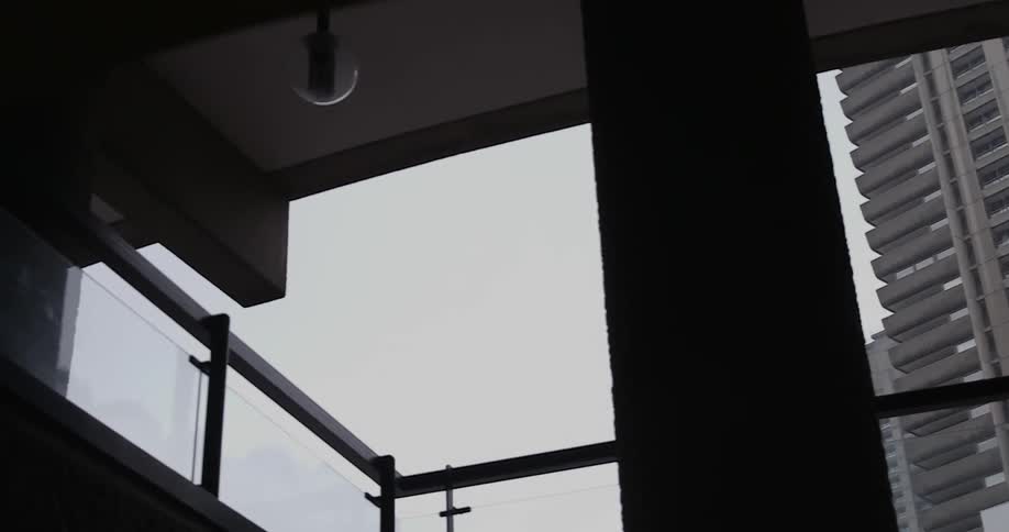 The cloudy sky is lined with a tall building