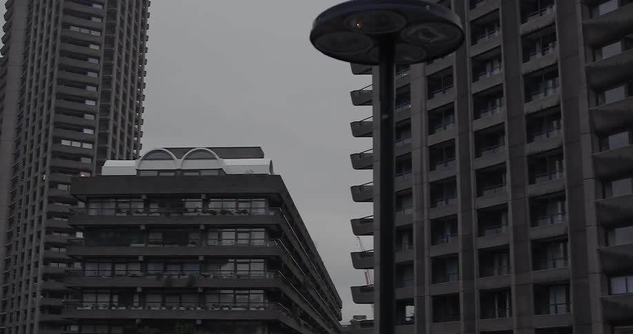 Gray clouds hover over city high rises during the day