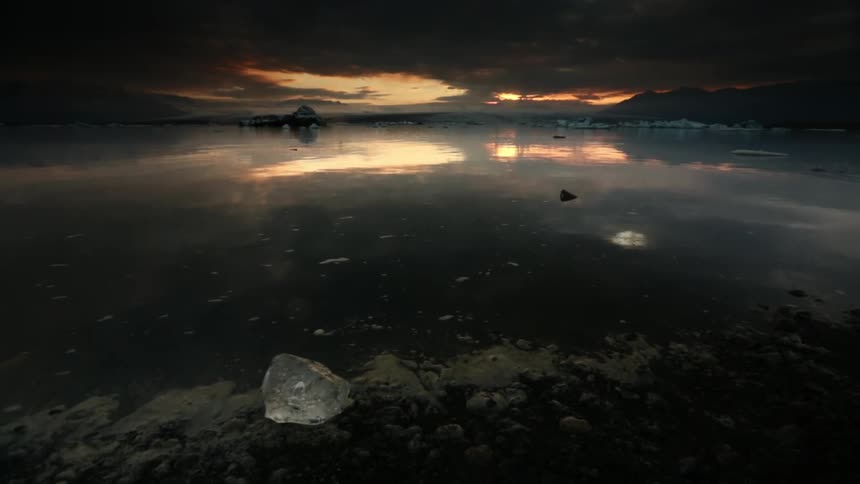 The water is calm with ice floating in parts