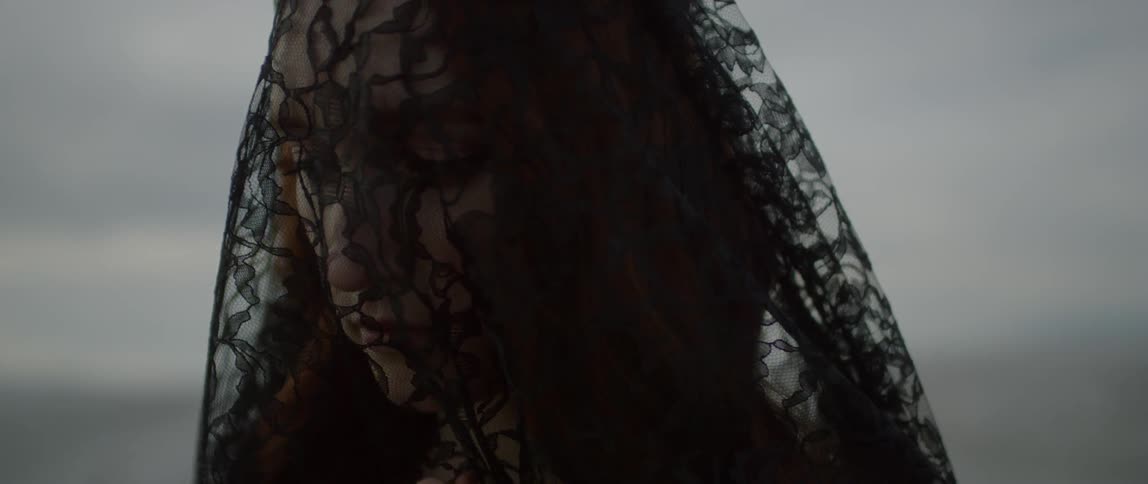 A woman is sad with a black veil on