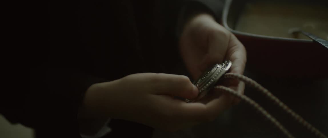 A child plays with a belt buckle