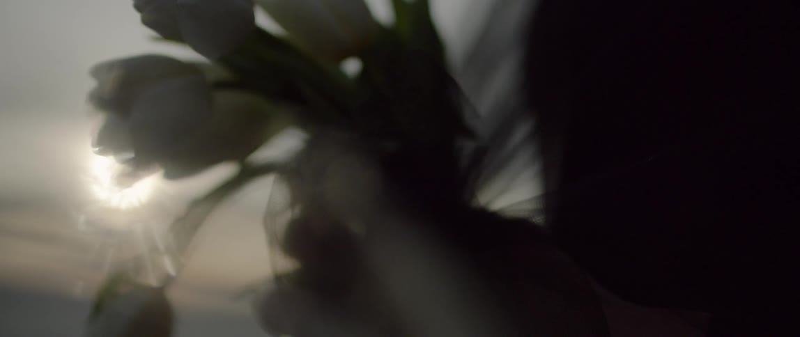 A woman holds a bouquet of tulips