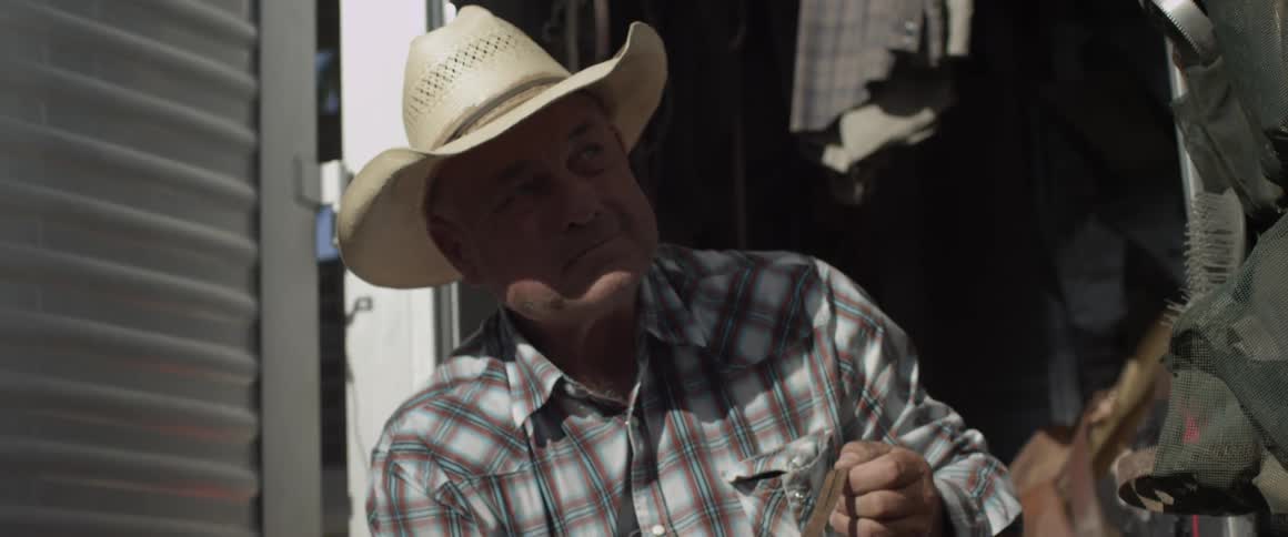 Man pulls on a strap and looks up