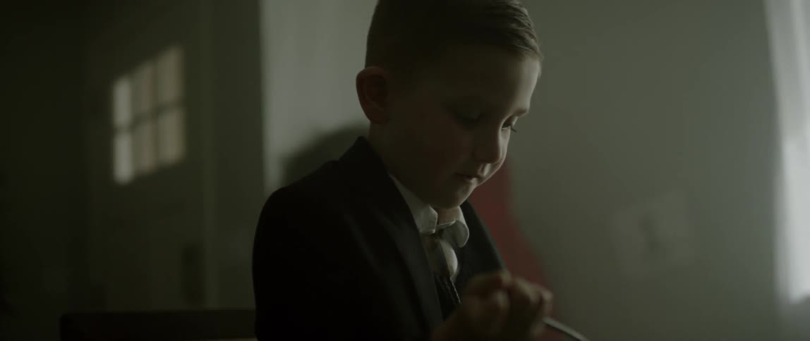 A boy is mixing something with a spoon