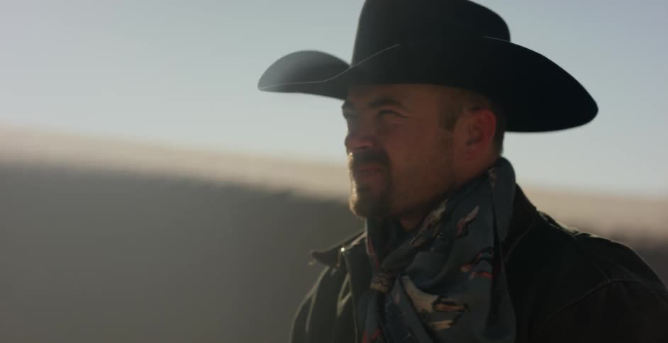 Man squints in a bright desert