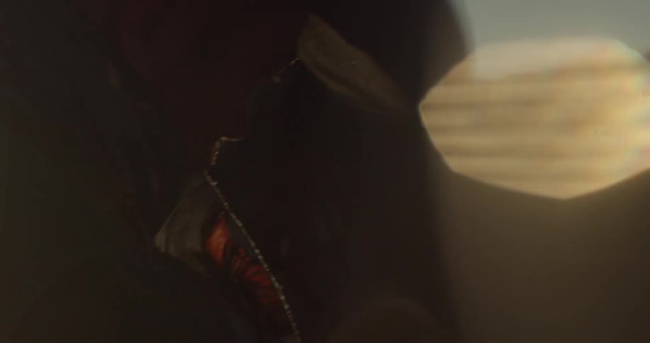 A man wearing a cowboy hat tends to a horse outside