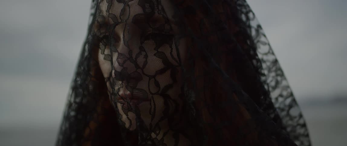 Woman outside wearing black lace covering over her head