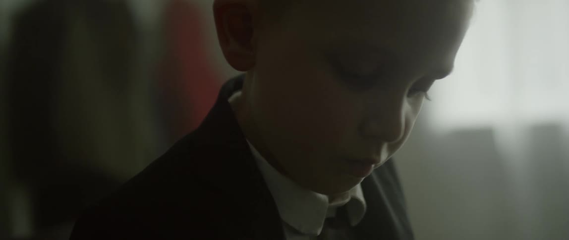 A child is wearing a suit