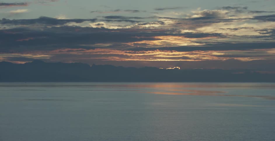 Clouds over body of water at sunset