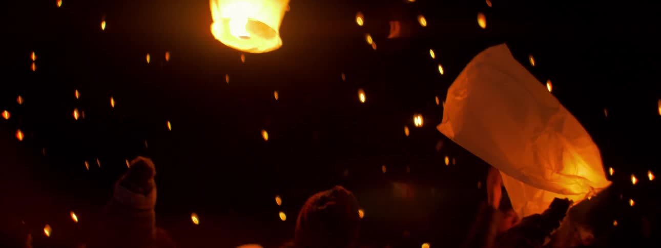 A girl releases a paper lantern