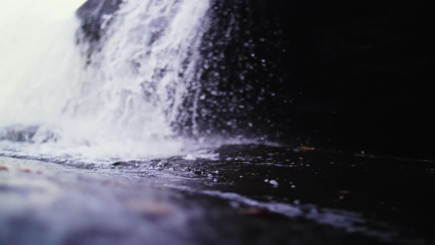 The water slowly crashes into the stream
