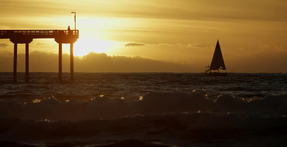 A boat is sailing in the rough water