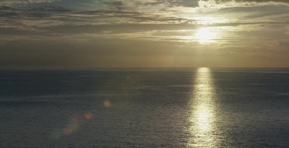 Sun rises over a large body of water