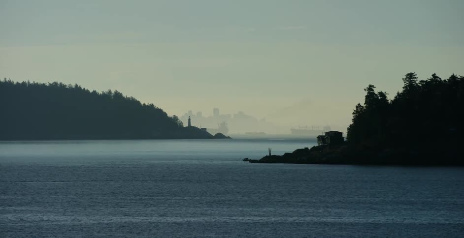 Water ripples around islands with city skyscrapers in the distance