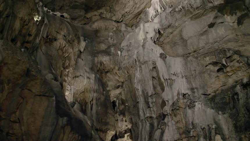 Geologic formations line the walls of a cave
