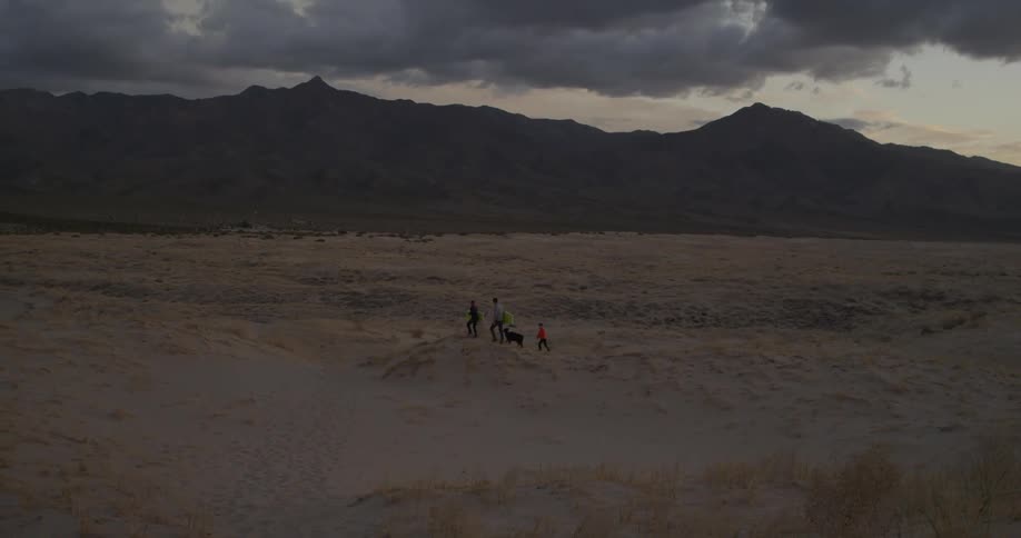 People are hiking in the distance in the desert