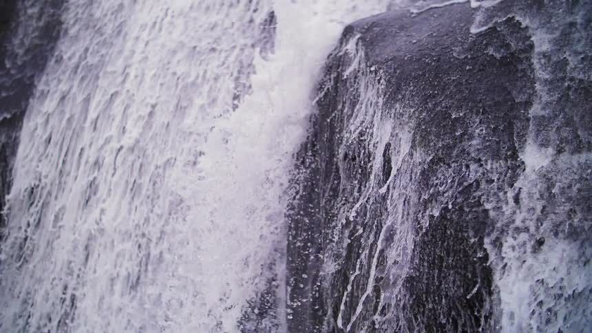Water cascades over a cliff