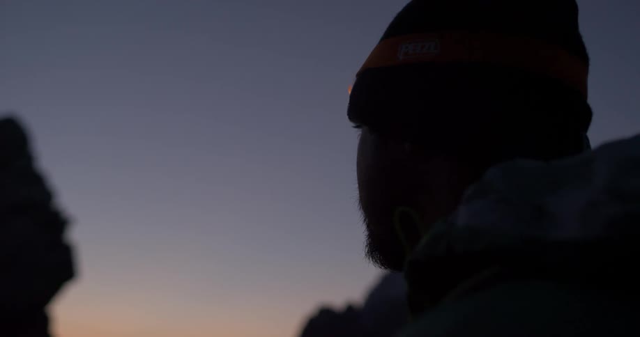 A man watches a sunset in the mountains