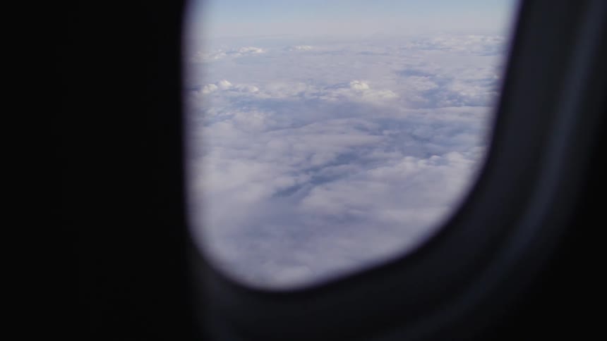 A plane flies over clouds