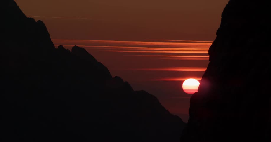 The sun is rising behind the mountains