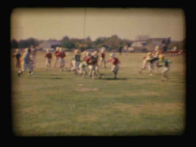 Two teams of children playing football