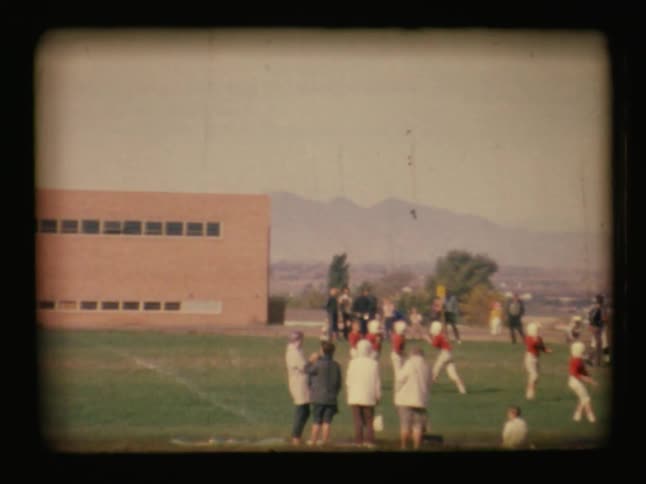 The football players are walking on the field