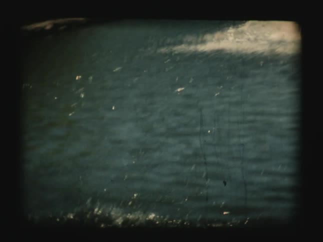 Man and child fish in a lake