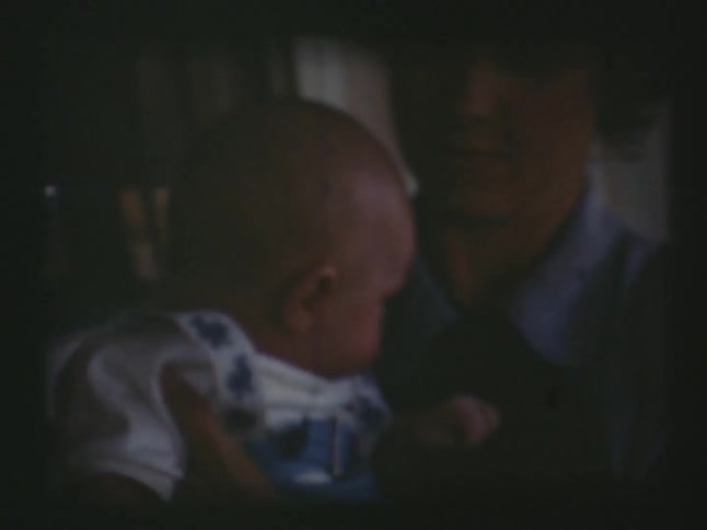 An older film of a woman holding a baby