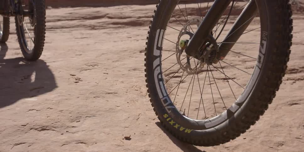 People riding bikes over a rocky ground