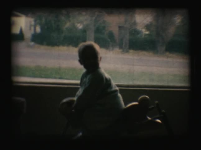 A young boy rides a bouncy horse toy
