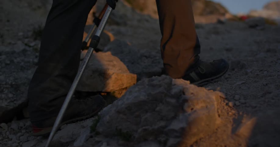 A man hikes up a rock cliffside