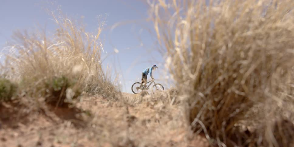 A person rides a trail bike on a sunny day