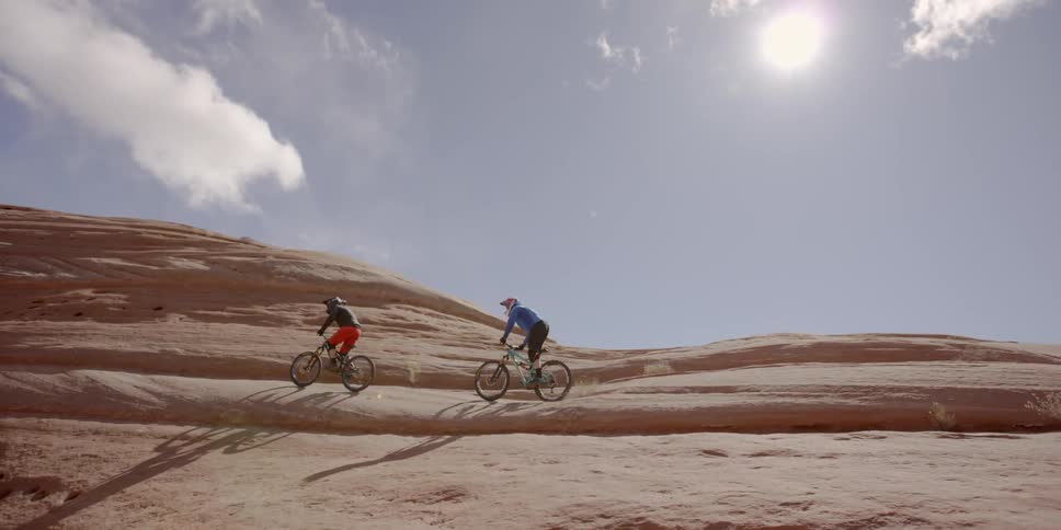 People ride their bicycles on the rocks