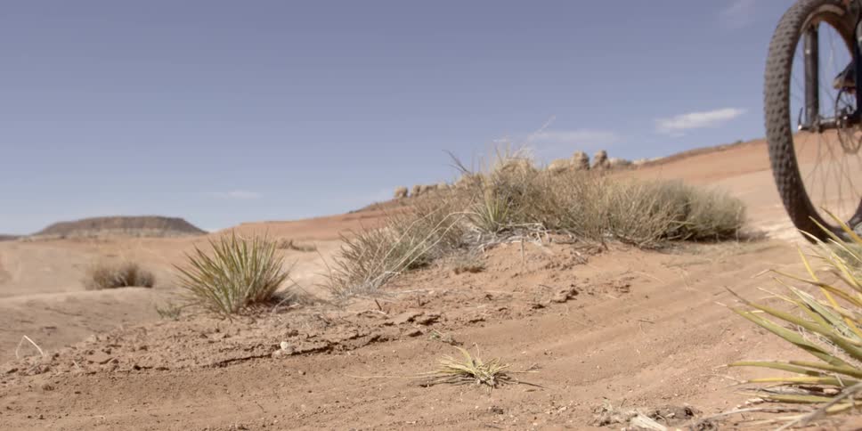 Person riding a bike in a desert