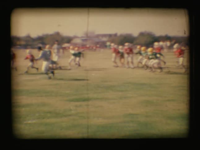 Vintage look at young kids playing a football game