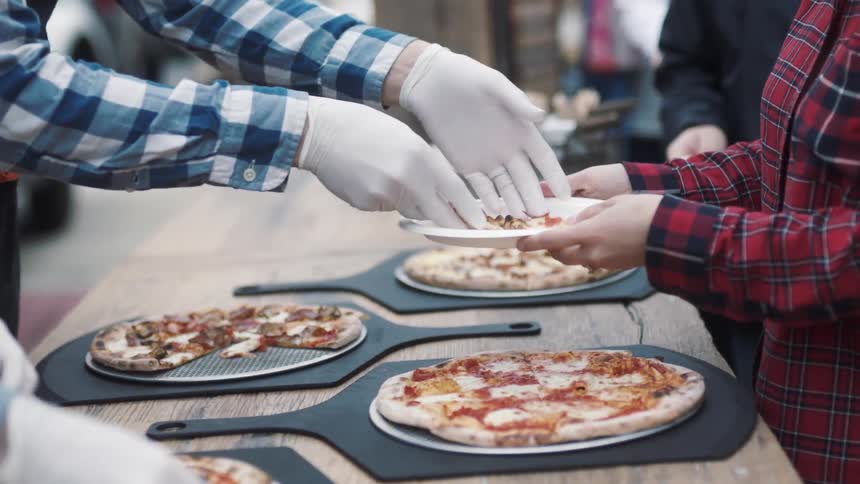People are being served pizza