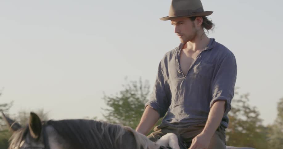 A man rides his horse slowly